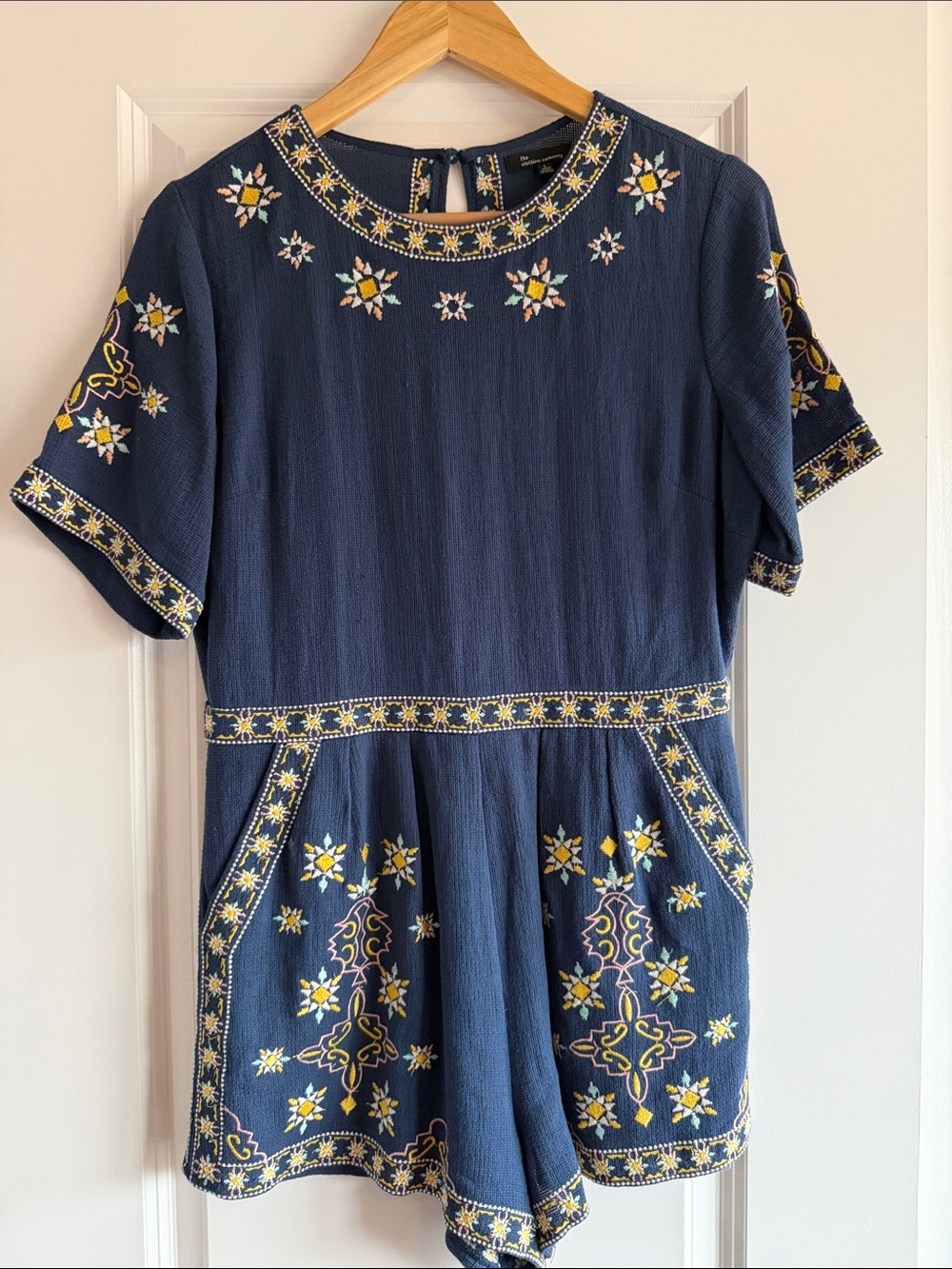 the clothing company Navy Blue Embroidered Romper